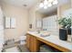 Well-lit bathroom featuring a shower and tub, vanity with sink, and white fixtures at 554 Rendevous Rd, Acworth, GA 30102