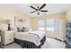 Serene bedroom with ceiling fan, two large windows, and elegant furnishings at 554 Rendevous Rd, Acworth, GA 30102