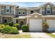 Charming townhome featuring a one-car garage and well-maintained landscaping for added curb appeal at 554 Rendevous Rd, Acworth, GA 30102