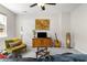 Bright living room features a ceiling fan and natural light with view of classic hardwood cabinet at 554 Rendevous Rd, Acworth, GA 30102