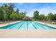 Beautiful community pool with lounge chairs, mature trees, and clear blue water at 554 Rendevous Rd, Acworth, GA 30102