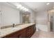 Spacious bathroom with a double sink vanity, soaking tub, and glass-enclosed shower at 855 Peachtree Ne St # 3205, Atlanta, GA 30308