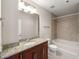 Bright bathroom with granite counters, a bath tub and a tile shower at 855 Peachtree Ne St # 3205, Atlanta, GA 30308