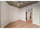 Bright bedroom with light hardwood floors with doorways into a bathroom and closet at 855 Peachtree Ne St # 3205, Atlanta, GA 30308