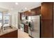 Well-equipped kitchen with stainless steel appliances, granite counters, and cherry wood cabinets at 855 Peachtree Ne St # 3205, Atlanta, GA 30308