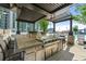 Outdoor kitchen with built-in BBQ, bar seating, and a pergola overlooking a pool at 855 Peachtree Ne St # 3205, Atlanta, GA 30308