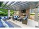 Relaxing outdoor lounge featuring a stone fireplace, TV, stylish seating, and a pergola at 855 Peachtree Ne St # 3205, Atlanta, GA 30308