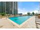 Luxury outdoor pool with lounge chairs, lush landscaping, and city views at 855 Peachtree Ne St # 3205, Atlanta, GA 30308