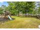 Spacious backyard featuring a wooden playset for outdoor recreation and fun at 1839 Tranquil Field Nw Dr, Acworth, GA 30102