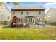 View of the home's backyard with a patio, playset, and mature lawn at 1839 Tranquil Field Nw Dr, Acworth, GA 30102