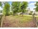 Extensive backyard with a playset, mature trees, and fencing at 1839 Tranquil Field Nw Dr, Acworth, GA 30102