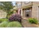 Inviting front porch showcasing lush landscaping and an American flag at 1839 Tranquil Field Nw Dr, Acworth, GA 30102