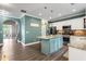 View of the open concept kitchen island with granite countertops, stainless appliances and breakfast bar at 1839 Tranquil Field Nw Dr, Acworth, GA 30102