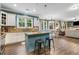 Open kitchen with granite countertops, seating at the island, and adjacent dining and living areas at 1839 Tranquil Field Nw Dr, Acworth, GA 30102