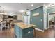 Open floorplan with kitchen island, dining area, and living room with fireplace and built-in shelving at 1839 Tranquil Field Nw Dr, Acworth, GA 30102