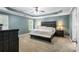 Spacious Primary bedroom with a king-size bed, tray ceiling, dark wood furniture, and soft lighting at 1839 Tranquil Field Nw Dr, Acworth, GA 30102