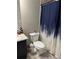 Cozy bathroom featuring granite countertop and patterned shower curtain at 2709 Ratby Ne Ln, Conyers, GA 30013