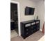 Bedroom with a TV above a black dresser, offering a stylish and functional space at 2709 Ratby Ne Ln, Conyers, GA 30013
