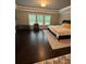 Spacious bedroom with hardwood floors, tray ceiling, and windows overlooking nature at 2709 Ratby Ne Ln, Conyers, GA 30013