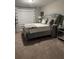Cozy bedroom featuring tufted headboard and carpet flooring at 2709 Ratby Ne Ln, Conyers, GA 30013