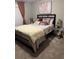 Well-appointed bedroom with plush pillows, elegant decor, and a modern aesthetic at 2709 Ratby Ne Ln, Conyers, GA 30013