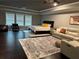 Spacious bedroom featuring many windows for natural light, dark floor, and neutral tones at 2709 Ratby Ne Ln, Conyers, GA 30013