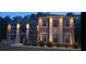 Stately brick home with stone accents, arched entry, and manicured landscaping at 2709 Ratby Ne Ln, Conyers, GA 30013