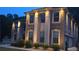 Stately brick home with stone accents, arched entry, and manicured landscaping at 2709 Ratby Ne Ln, Conyers, GA 30013
