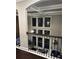 Upstairs hallway featuring large windows and natural light at 2709 Ratby Ne Ln, Conyers, GA 30013