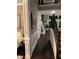 Elegant hallway featuring dark hardwood floors, wainscoting, and a staircase leading to the upper level at 2709 Ratby Ne Ln, Conyers, GA 30013