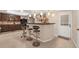 Finished basement bar with dark cabinets, bar stools, and rear door at 3310 Vista Creek Dr, Dacula, GA 30019