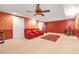 Basement bonus room features red walls, comfy seats, and neutral carpet at 3310 Vista Creek Dr, Dacula, GA 30019