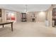 Spacious carpeted basement with white fireplace and adjacent sitting room at 3310 Vista Creek Dr, Dacula, GA 30019