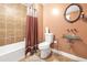 This bathroom features a glass bowl sink, tile, and toilet; all in earth tones at 3310 Vista Creek Dr, Dacula, GA 30019