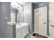 Well-lit bathroom featuring a white vanity with a modern mirror and decorative accents at 3310 Vista Creek Dr, Dacula, GA 30019