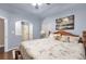 Bedroom boasting arched doorway, light blue walls, and decoratively styled queen bed at 3310 Vista Creek Dr, Dacula, GA 30019