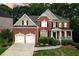 Beautiful two-story brick home with a well-manicured lawn and a two-car garage at 3310 Vista Creek Dr, Dacula, GA 30019