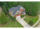 Birds-eye view of a red brick house featuring a two-car garage and mature landscaping at 3310 Vista Creek Dr, Dacula, GA 30019