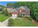 An eye-level view of a stunning two-story brick home with landscaped grounds at 3310 Vista Creek Dr, Dacula, GA 30019