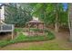 A backyard gazebo offers a tranquil retreat, complete with landscaping and seating at 3310 Vista Creek Dr, Dacula, GA 30019