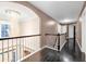 Hallway with railing overlooking entry foyer and an elegant chandelier at 3310 Vista Creek Dr, Dacula, GA 30019