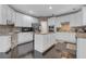 A spacious kitchen with white cabinets, a center island with granite countertops, and stainless steel appliances at 3310 Vista Creek Dr, Dacula, GA 30019