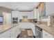 Bright kitchen with island, stainless steel appliances, granite counters and white cabinetry at 3310 Vista Creek Dr, Dacula, GA 30019