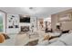 Bright living room featuring a fireplace, built-in shelves and large white sectional sofa with modern chandelier at 3310 Vista Creek Dr, Dacula, GA 30019