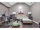 Neutral living room with glass coffee table, desk, and picture window at 3310 Vista Creek Dr, Dacula, GA 30019