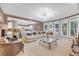 Open concept living area with large windows, neutral decor, and a view of the kitchen at 3310 Vista Creek Dr, Dacula, GA 30019