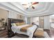 Main bedroom featuring a tray ceiling, adjoining living area, and hardwood flooring at 3310 Vista Creek Dr, Dacula, GA 30019