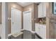 Functional mud room with white cabinets and dark wood floor at 3310 Vista Creek Dr, Dacula, GA 30019