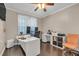 Well-lit home office with ample desk space, modern furniture, and wood flooring at 3310 Vista Creek Dr, Dacula, GA 30019