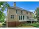 A lovely tan home features a full, finished basement, sunroom, and wooden deck at 3310 Vista Creek Dr, Dacula, GA 30019